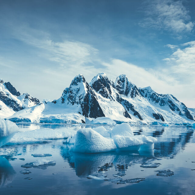 Blue ice-covered mountains in the Arctic near the North Pole.