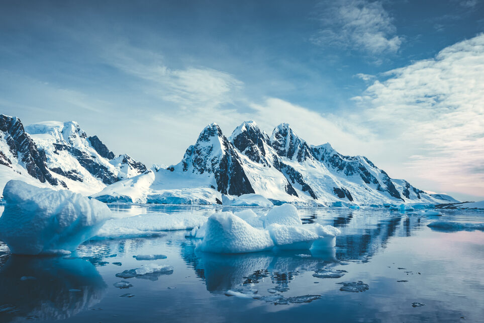 Blue ice-covered mountains in the Arctic near the North Pole.