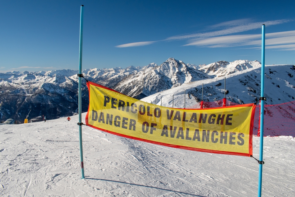 Safety sign warning skiers of a potential risk of avalanche.